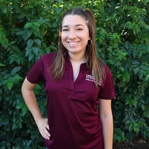 a person standing in front of a bush