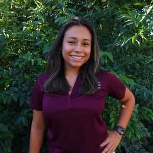 a person standing in front of a bush