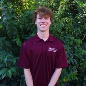 a person standing in front of a bush