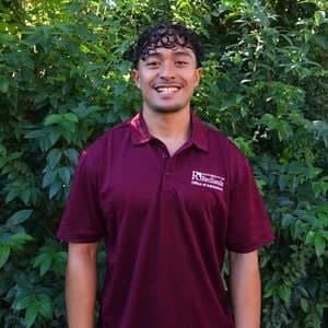 a person standing in front of bushes