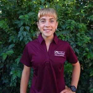 a person standing in front of a bush