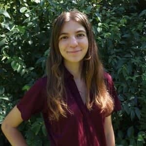 a person standing in front of a bush