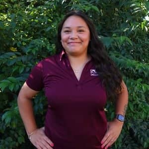 a person standing in front of a bush