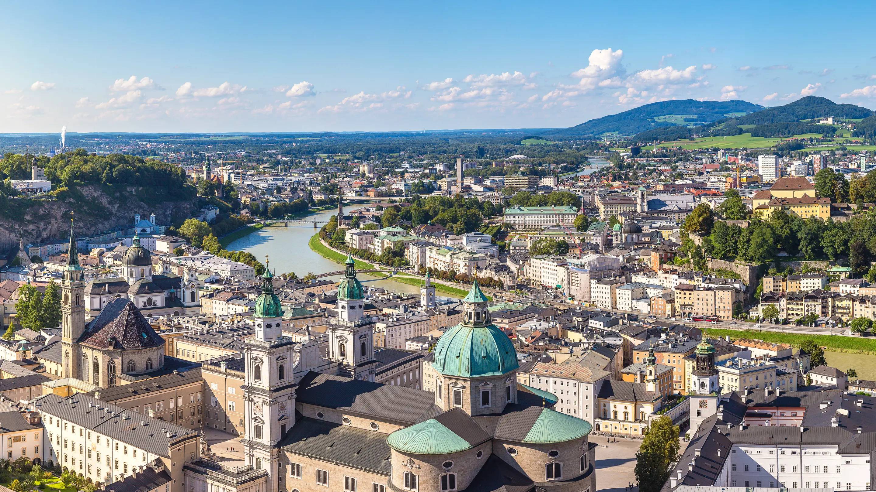a city with a river and a blue sky