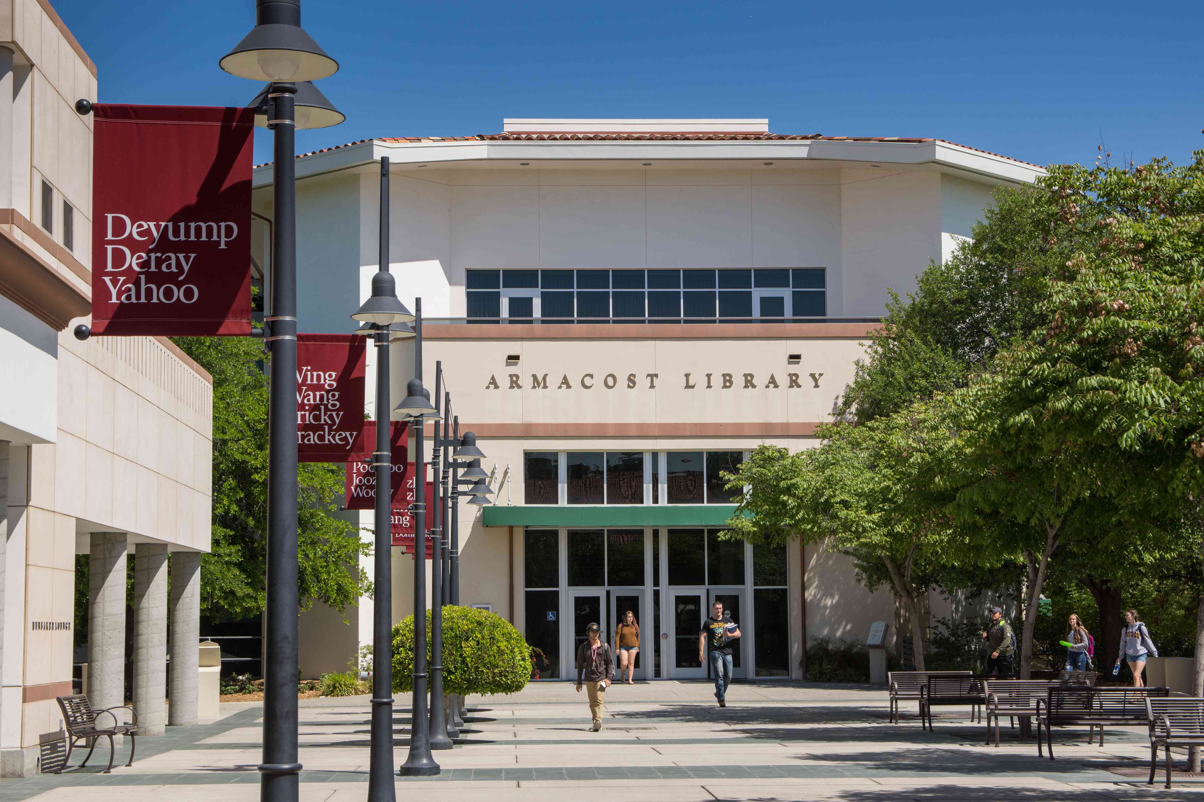 a group of people walking in front of a library