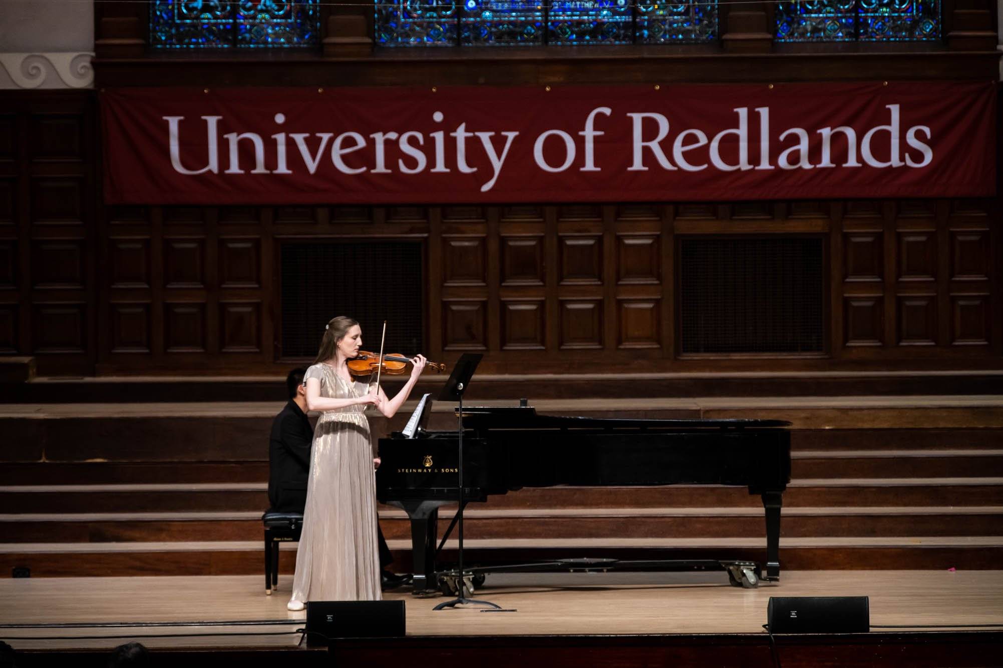 a person playing a violin on a stage