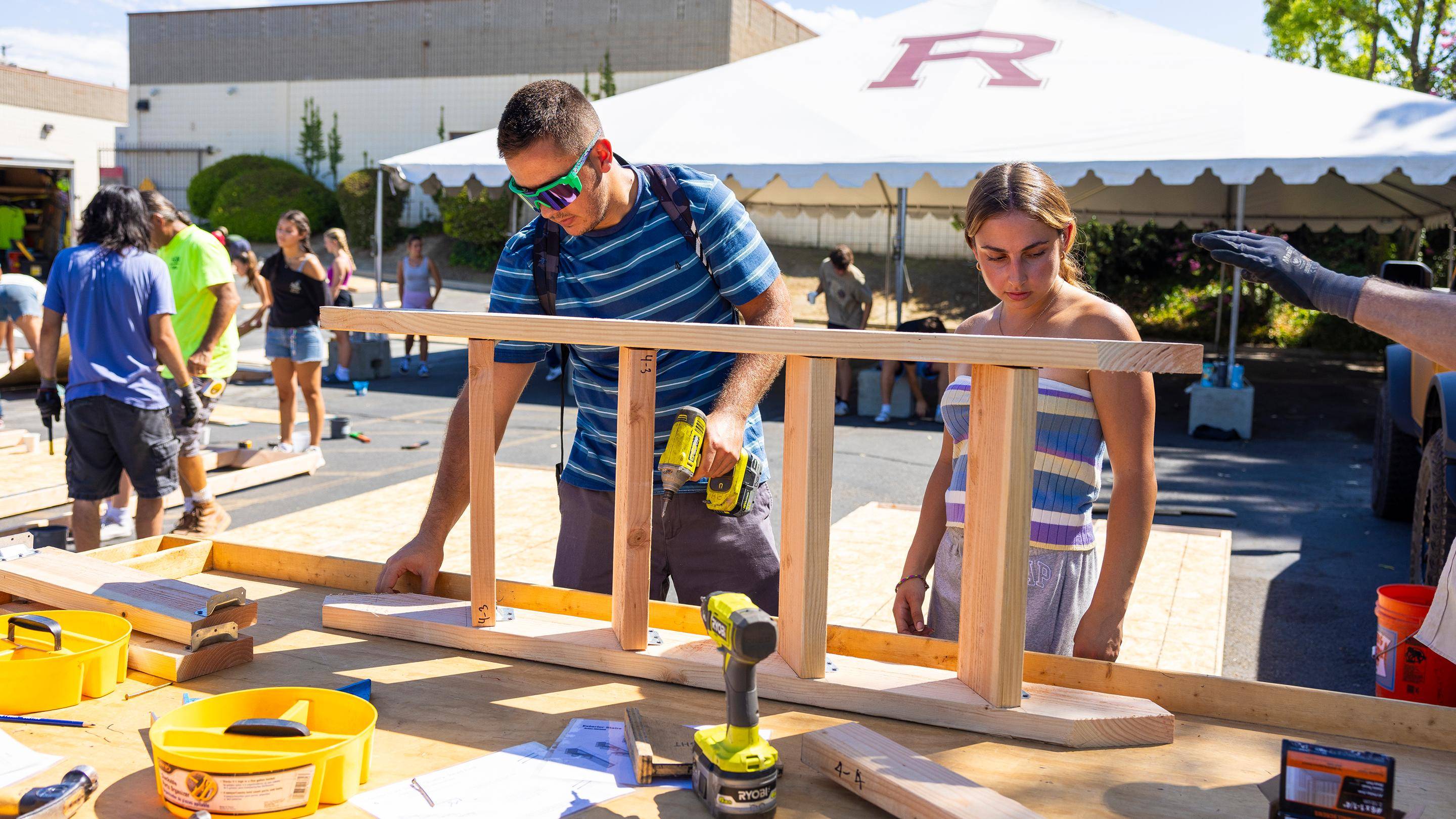 a person and person working on a wood piece