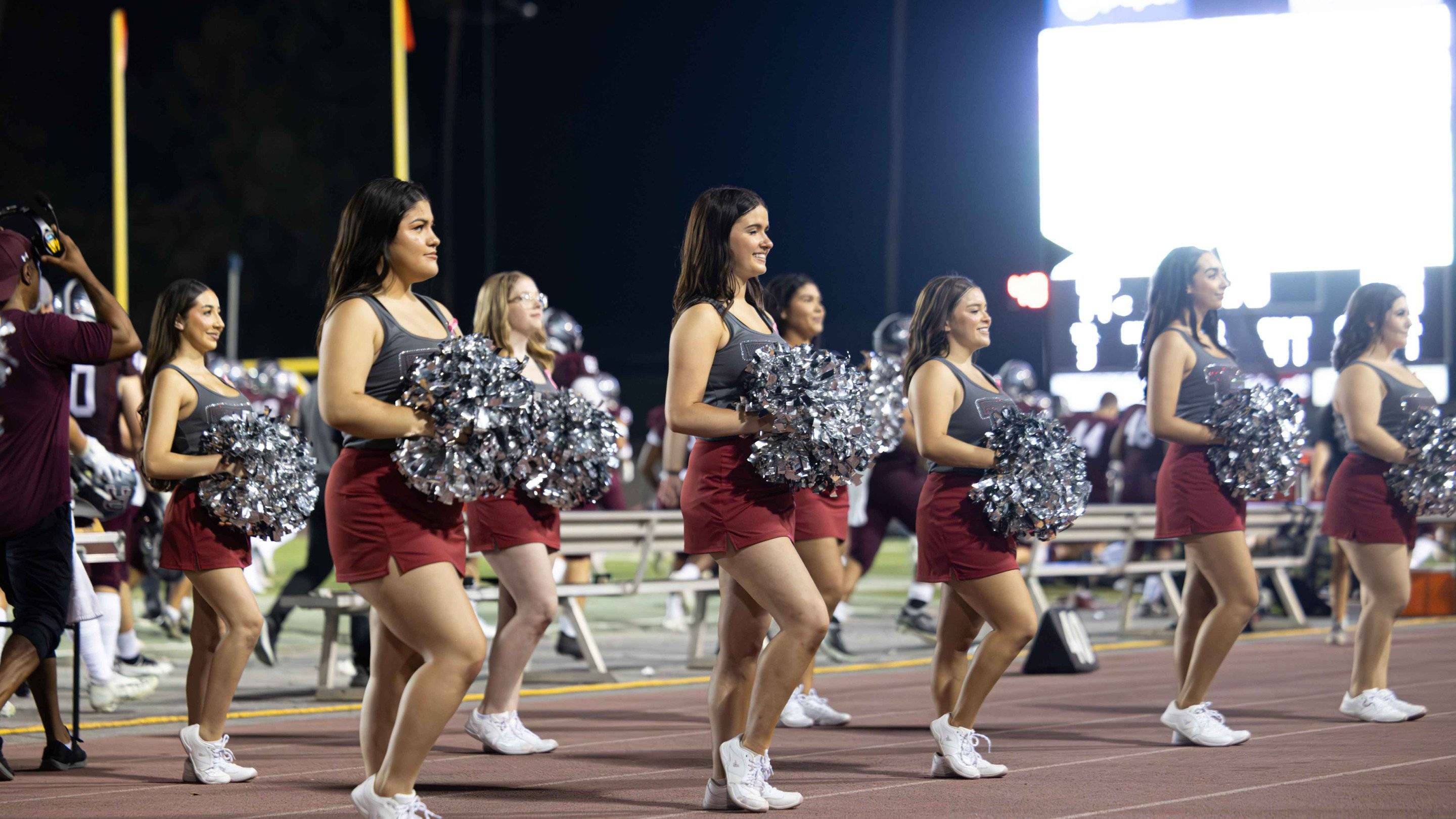 a group of cheerleaders on a track