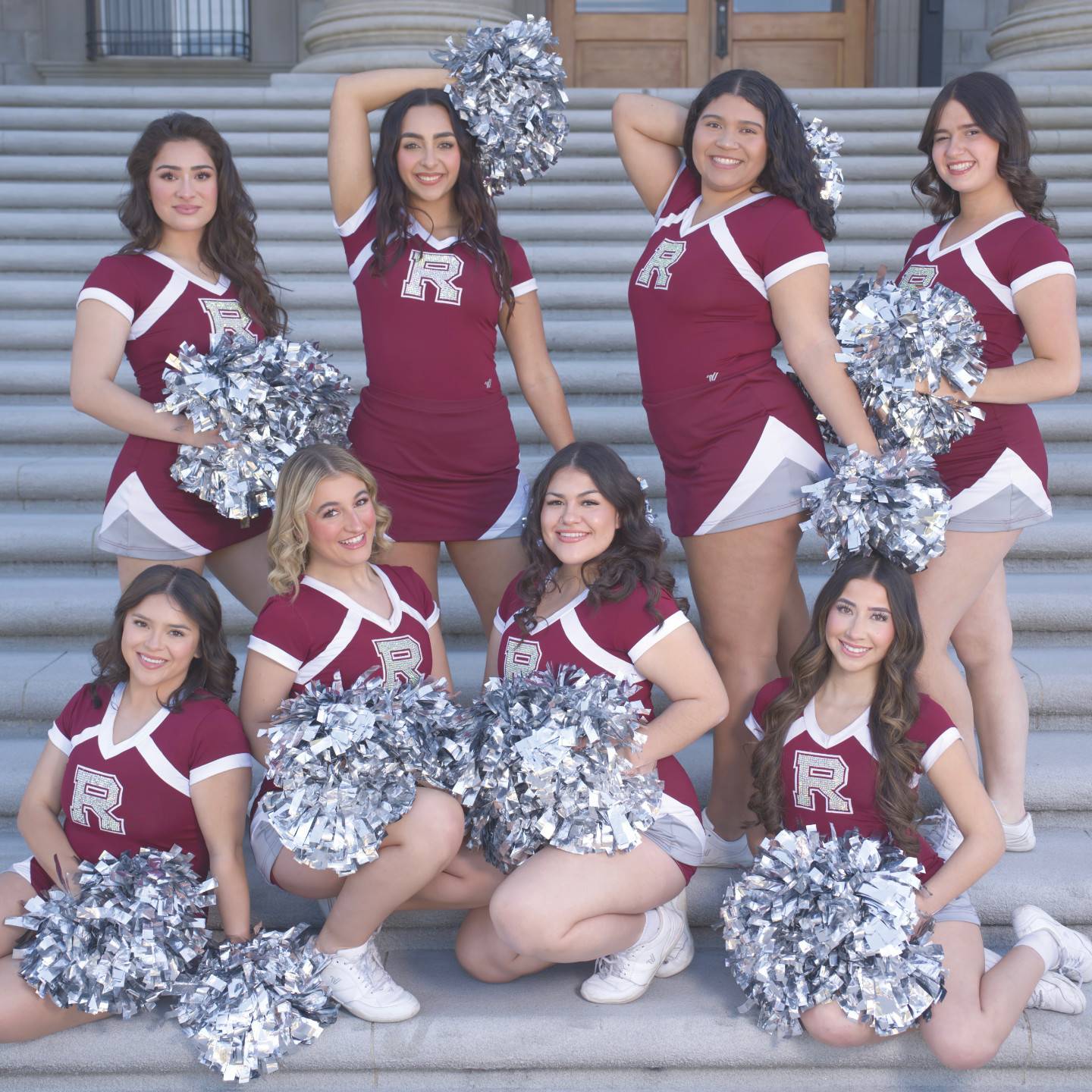 a group of cheerleaders posing for a photo