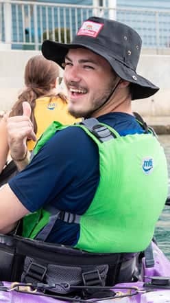 a person wearing a hat and a life jacket