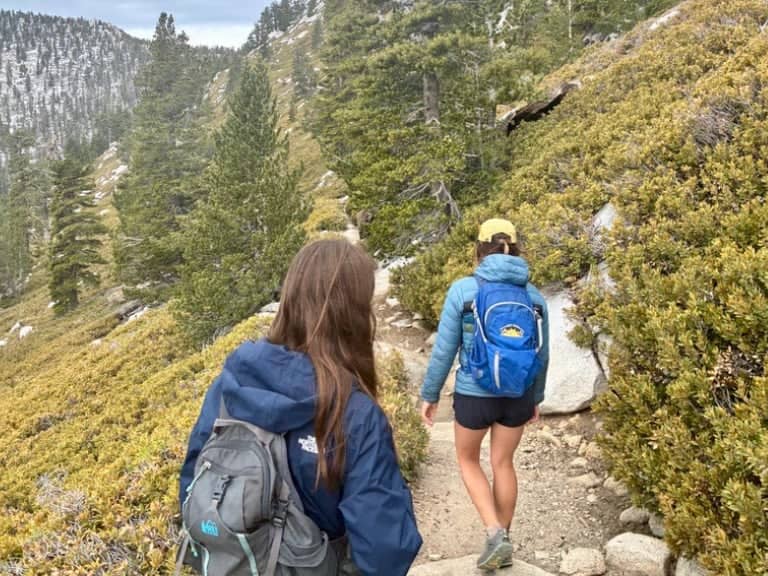 two women hiking on a rocky path