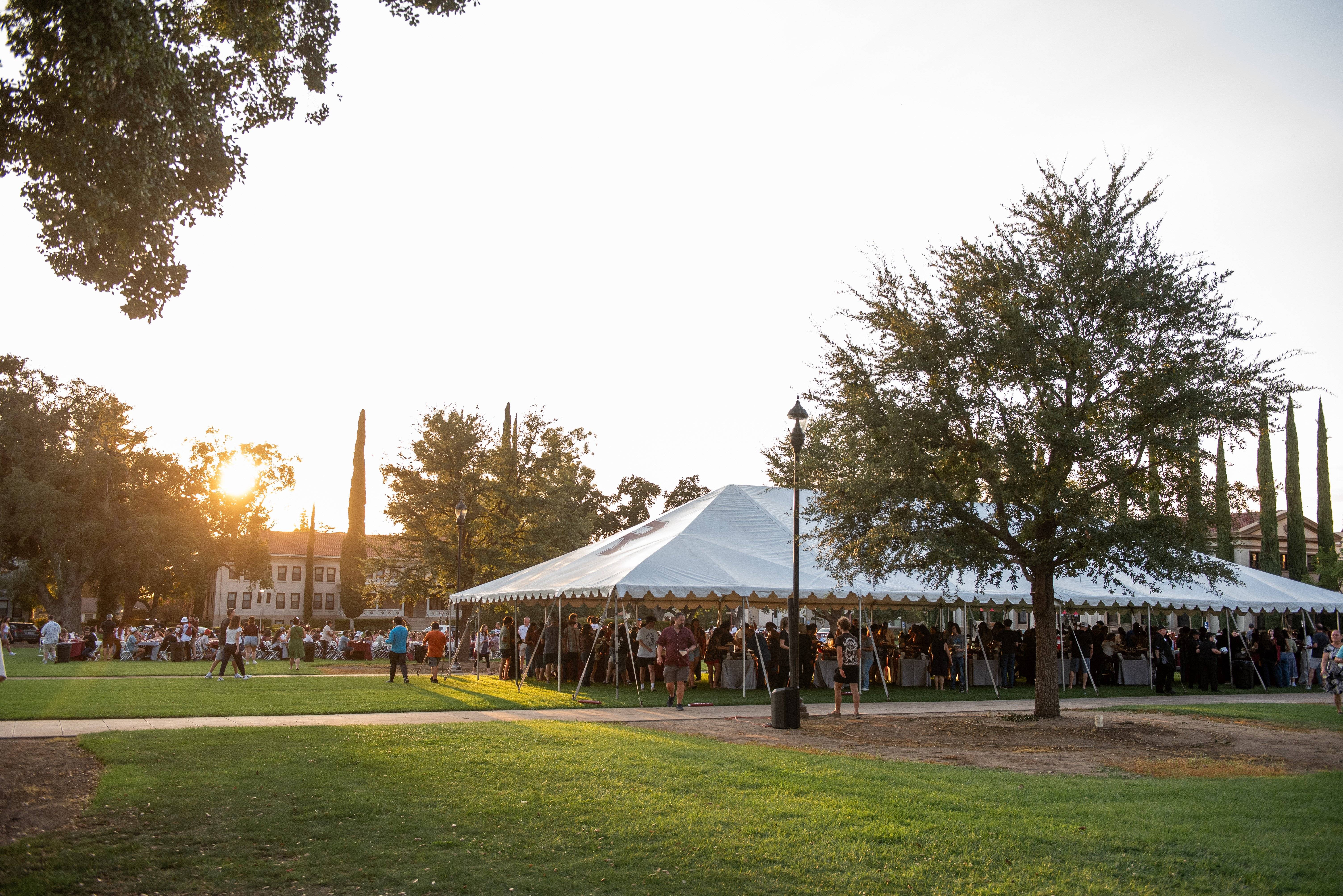 a group of people under a white tent