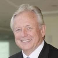 a person in a suit smiling