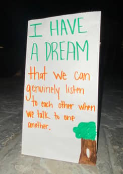A poster says I have a dream that we can genuinely listen to each other when we talk to one another