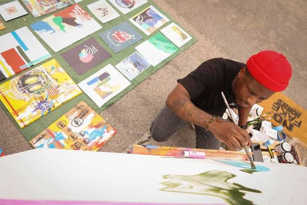 a person painting on canvas