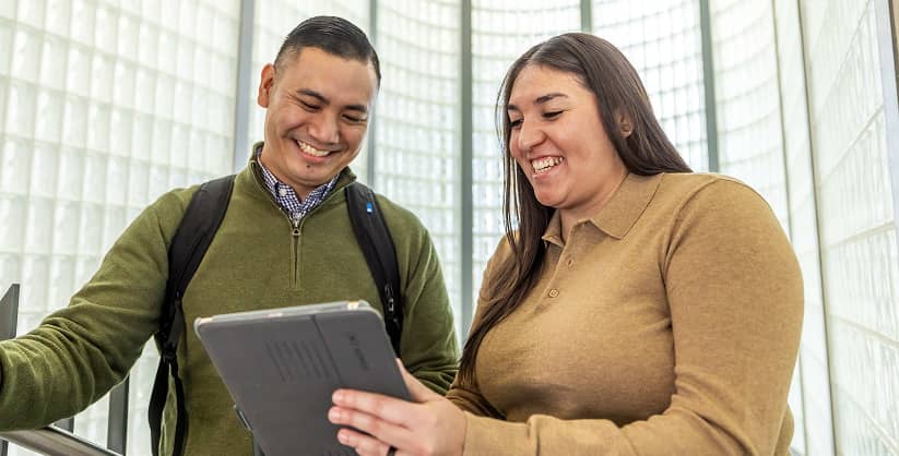 a person and person looking at a tablet