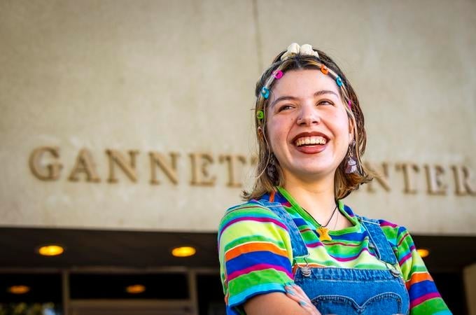 a woman smiling with colorful hair