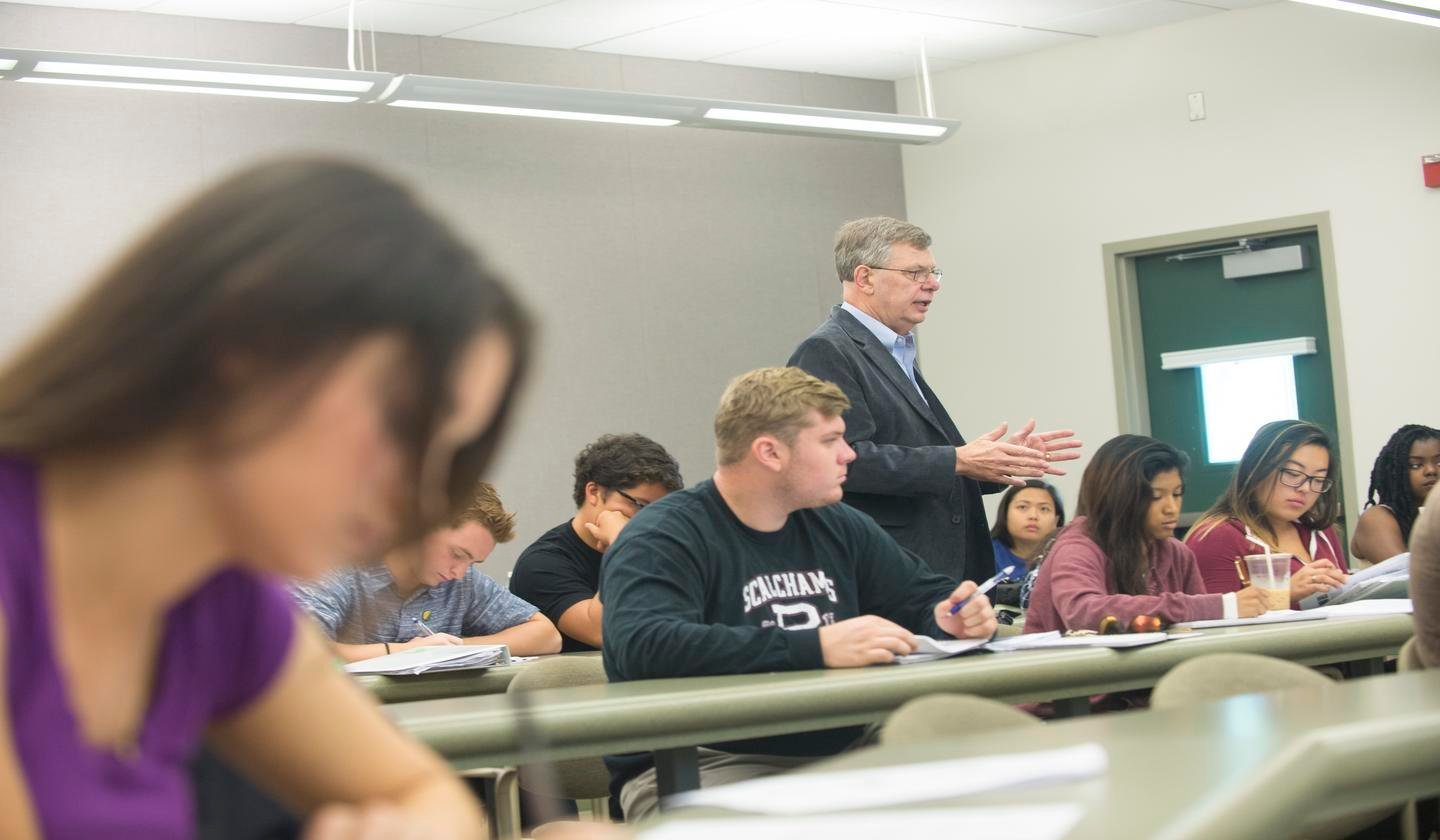 a man standing in front of a group of students