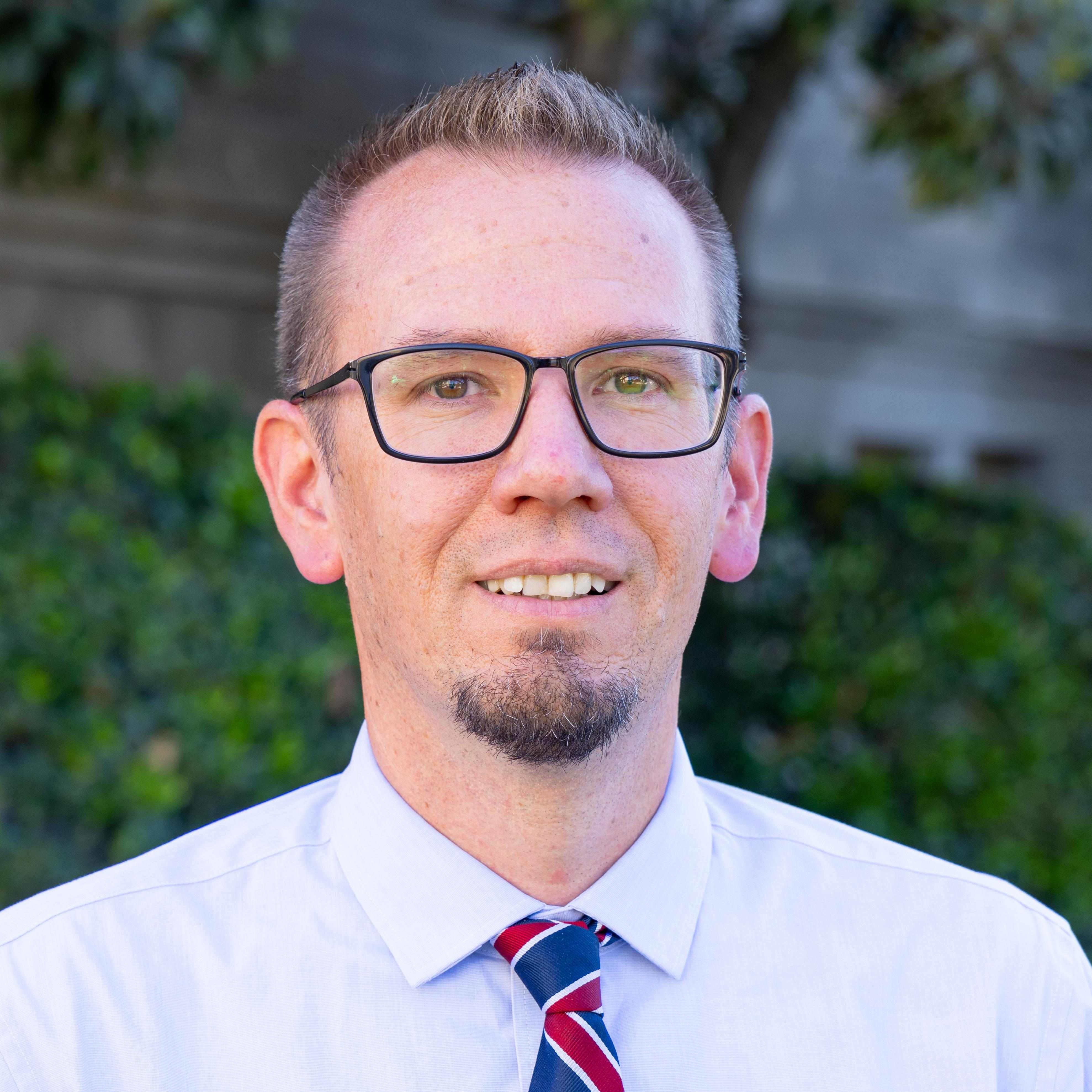 a person wearing glasses and a tie