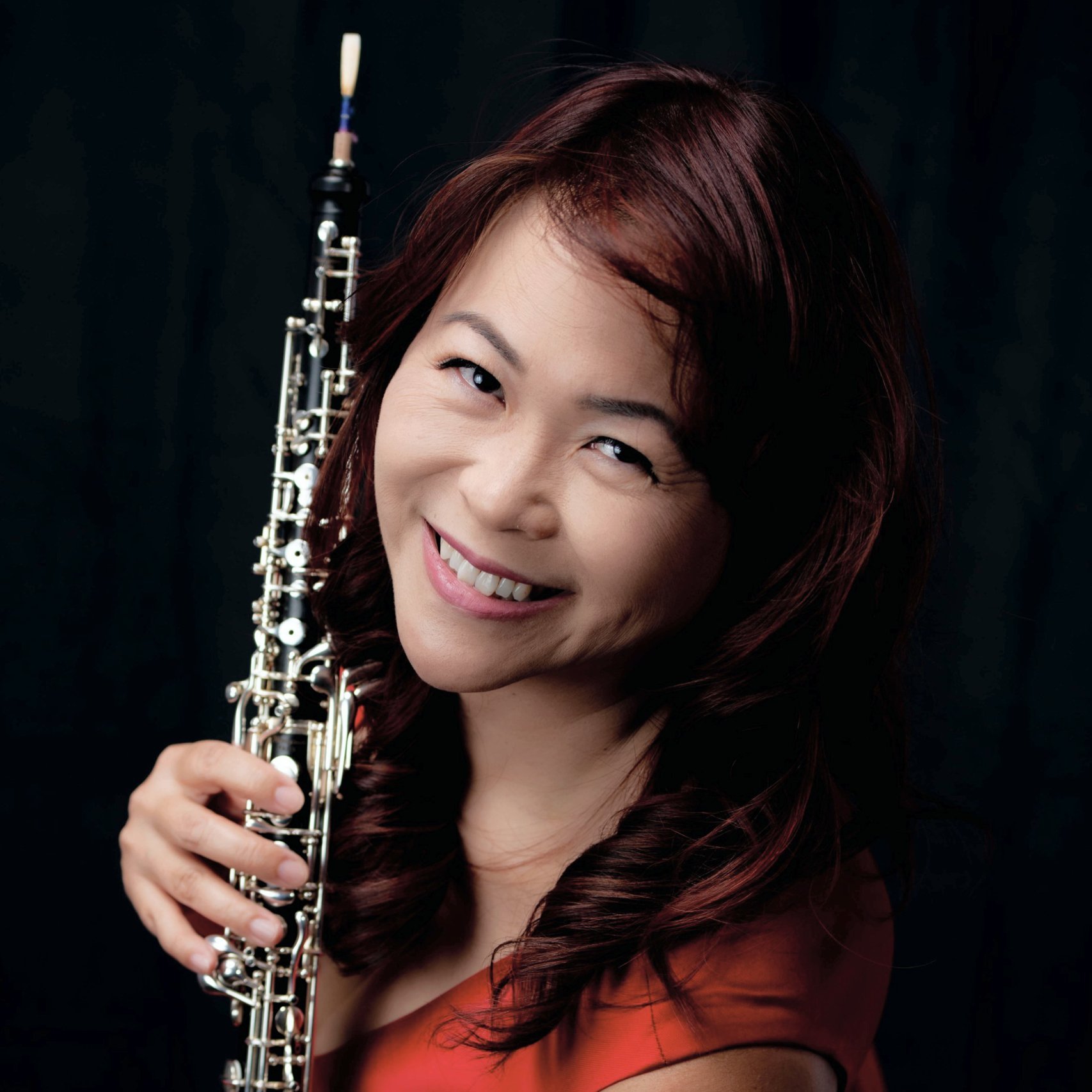 a woman holding a clarinet