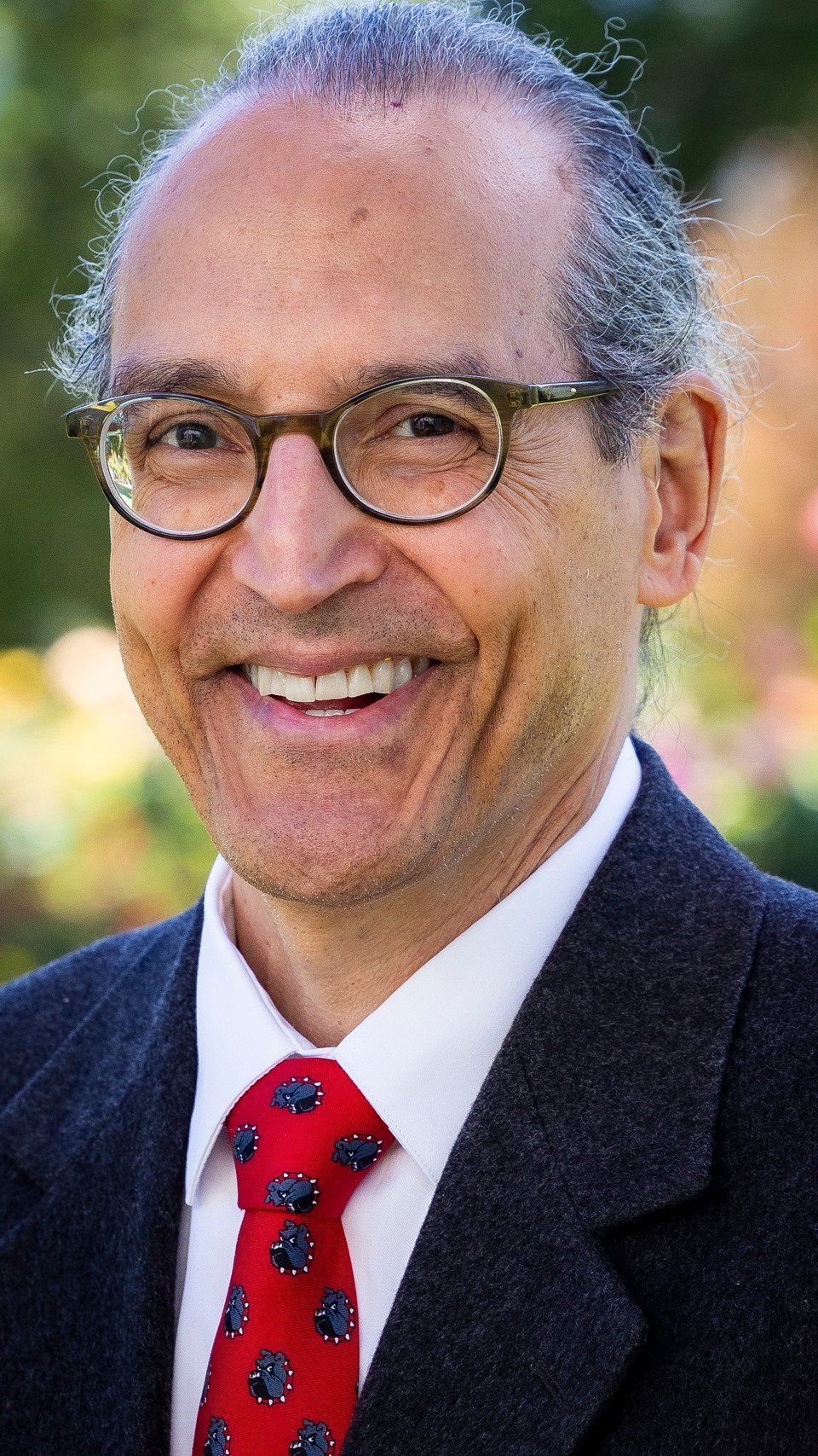 a man wearing glasses and a suit