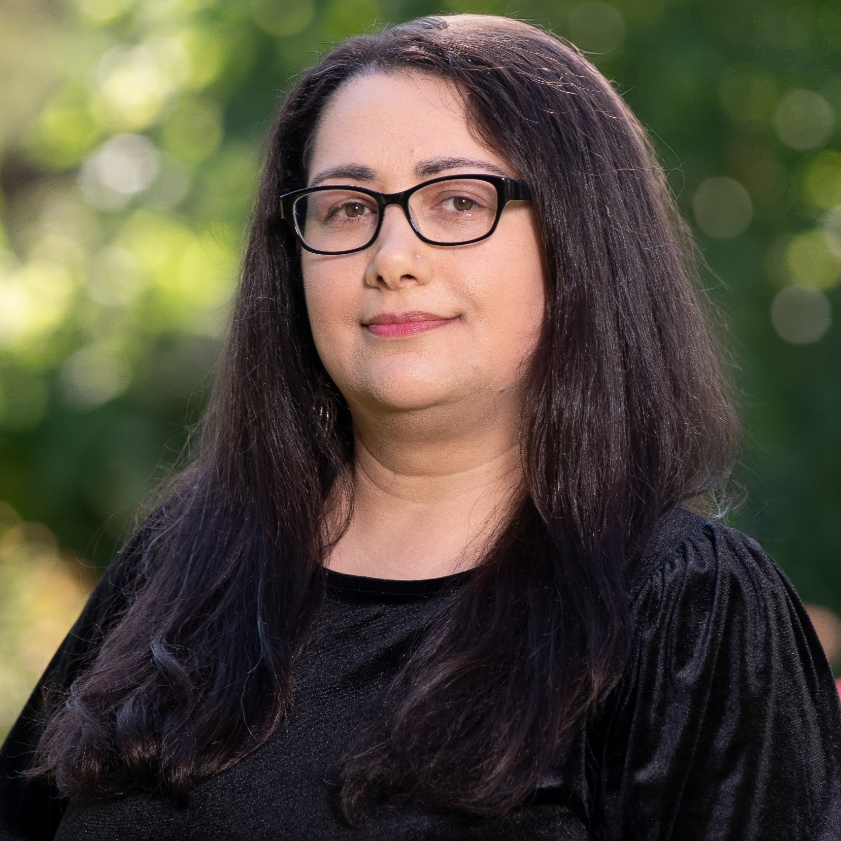 a woman with long hair wearing glasses