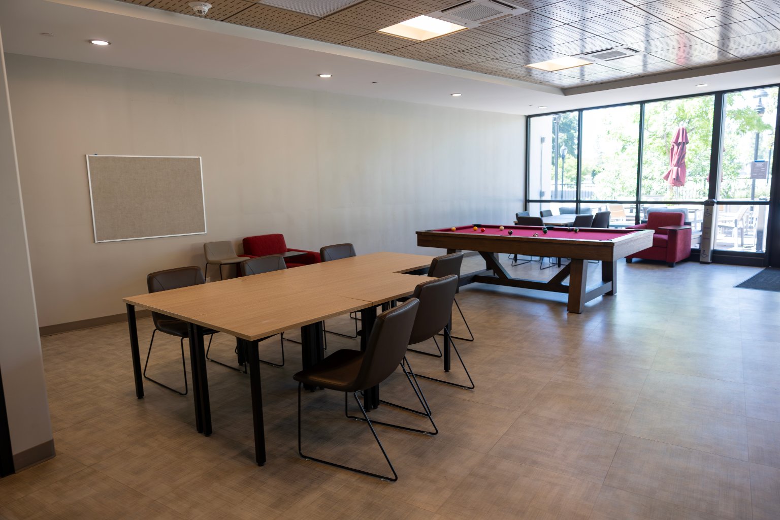 a pool table and chairs in a room
