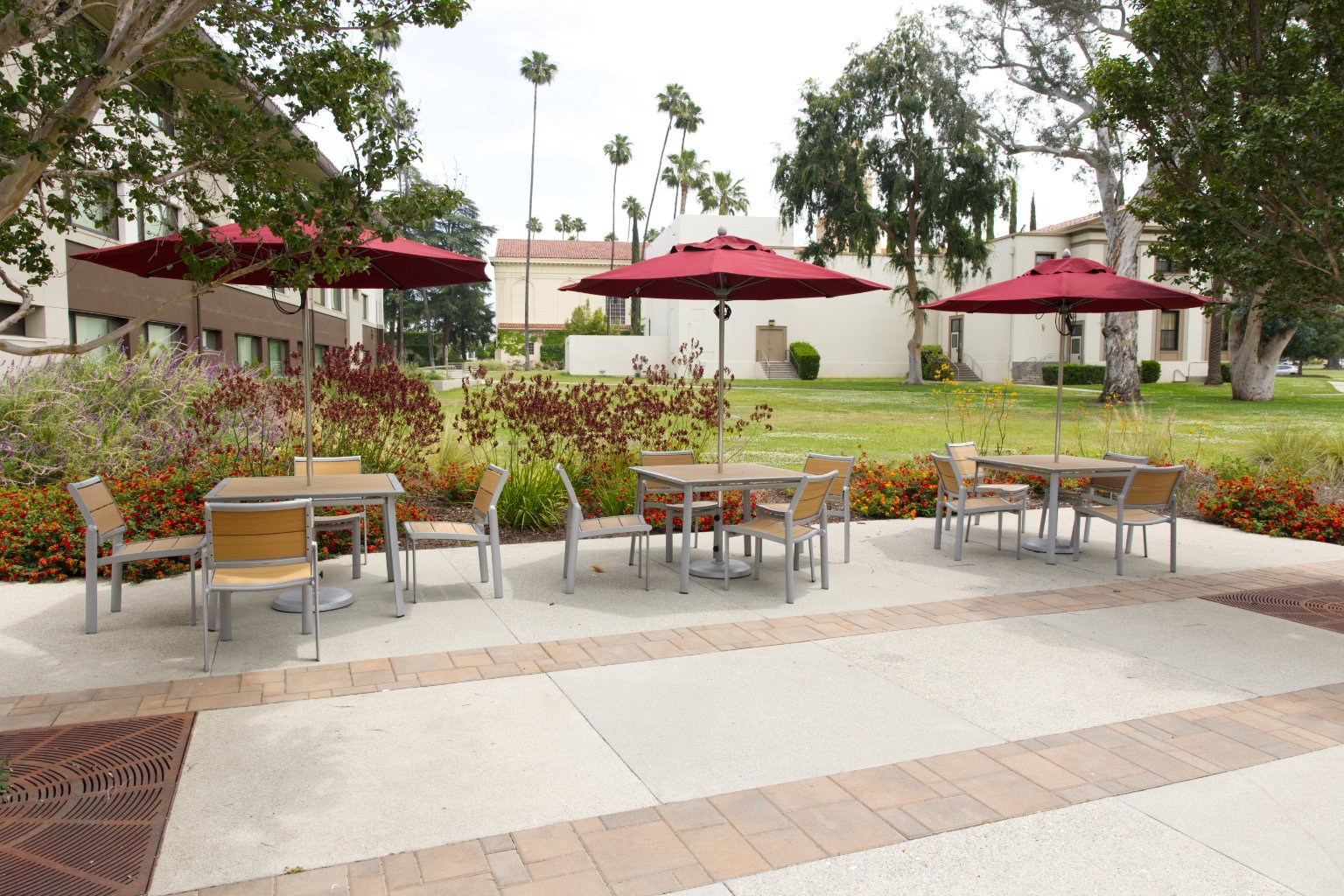 a group of tables and chairs with umbrellas