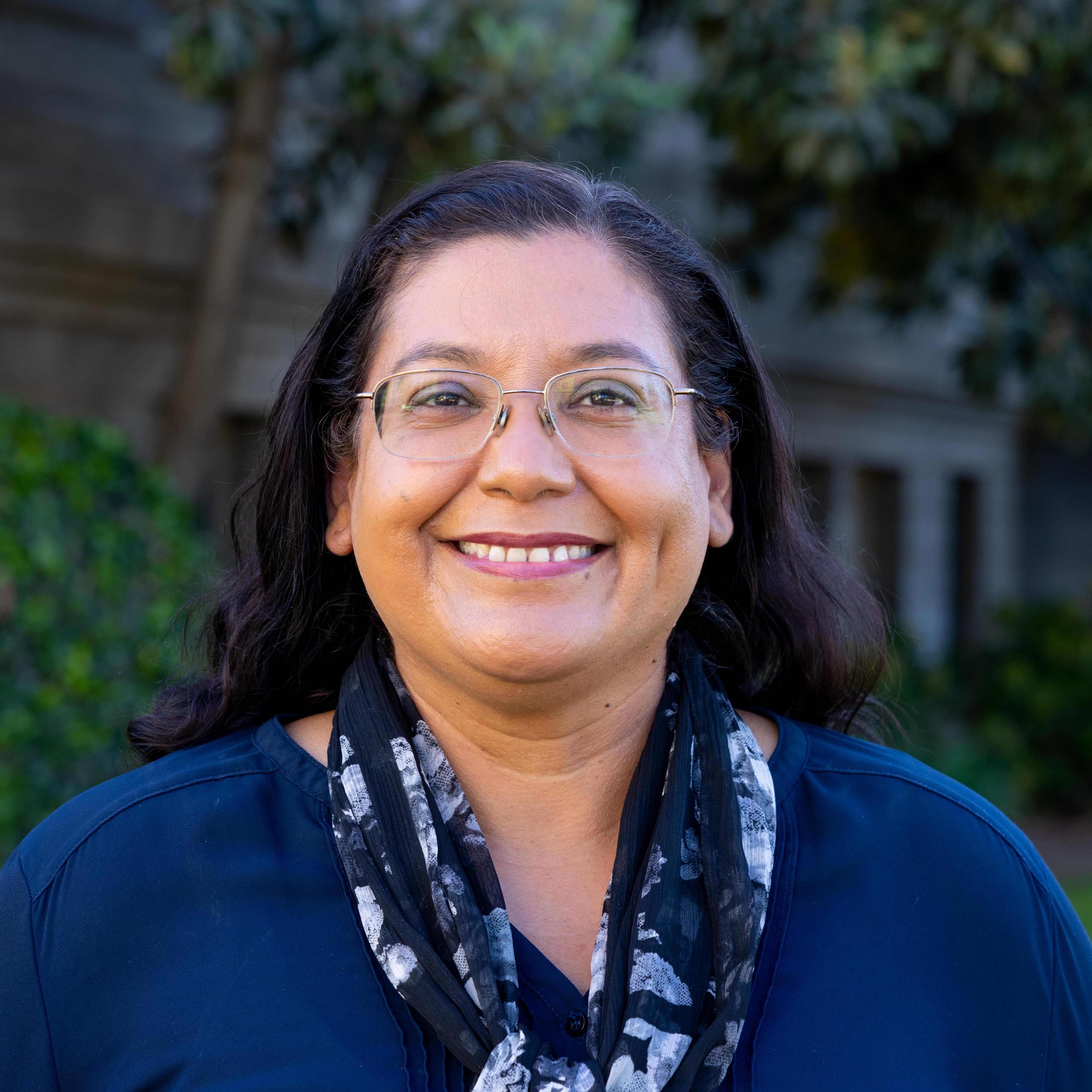 a person wearing glasses and a scarf