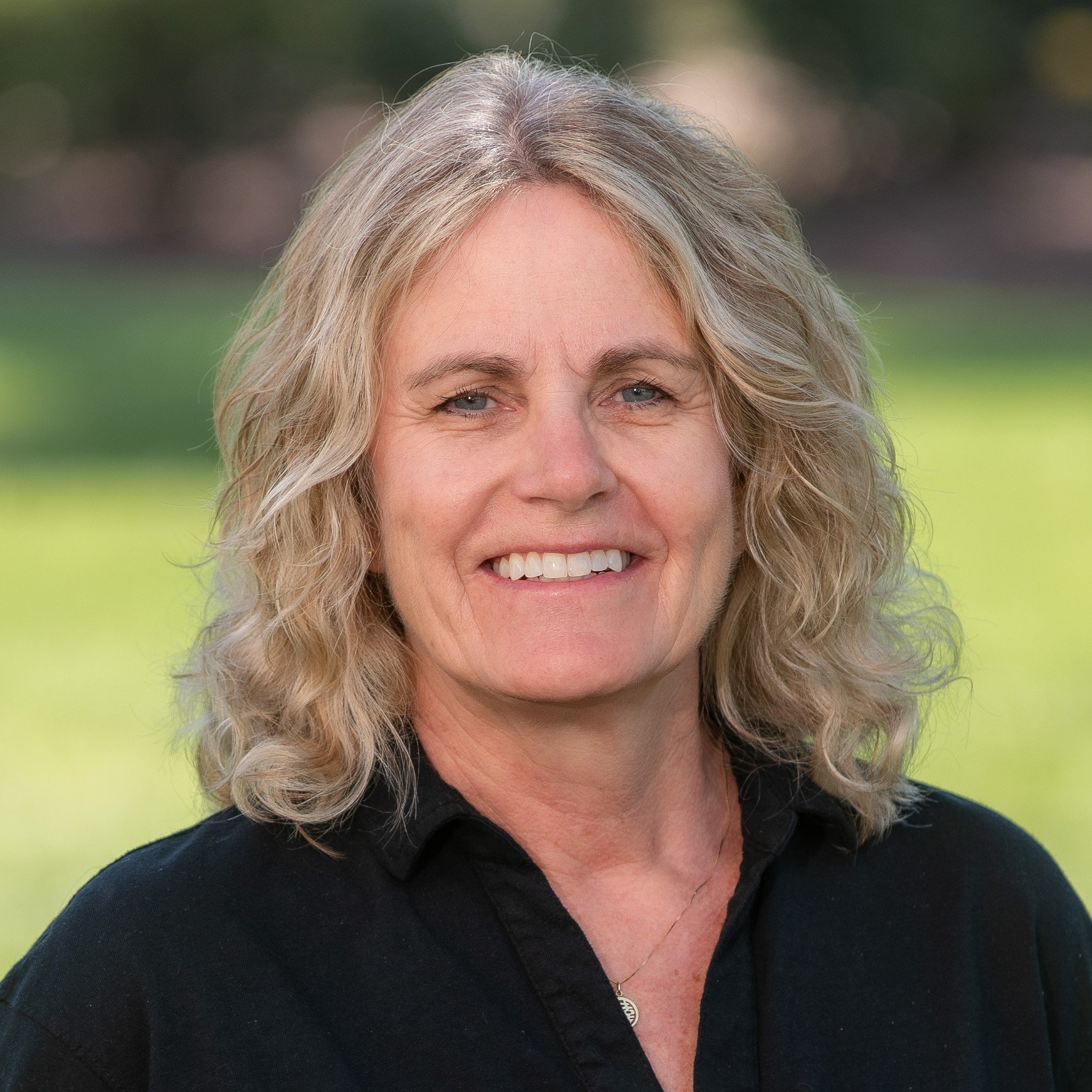 a woman with blonde hair smiling