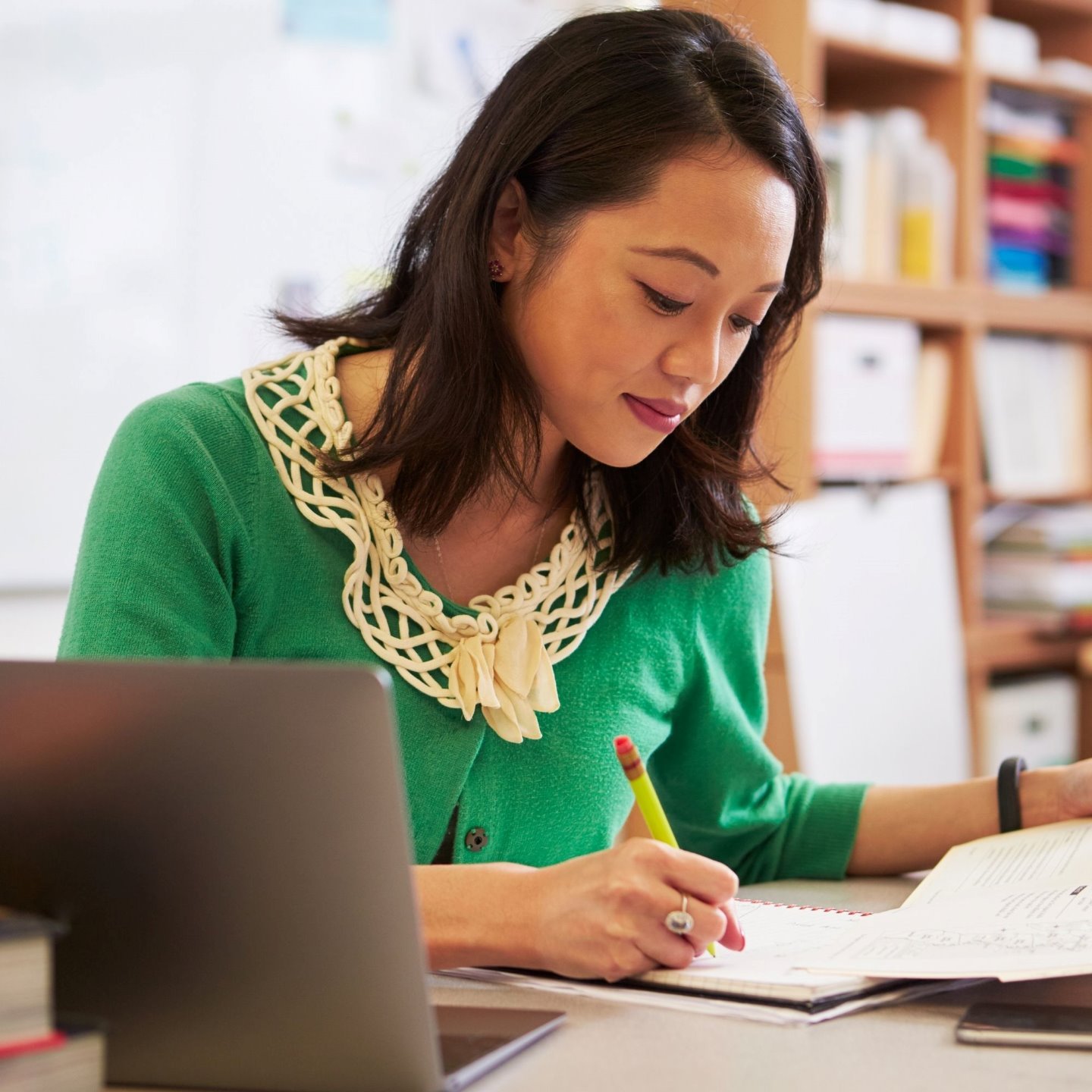a woman writing on a piece of paper