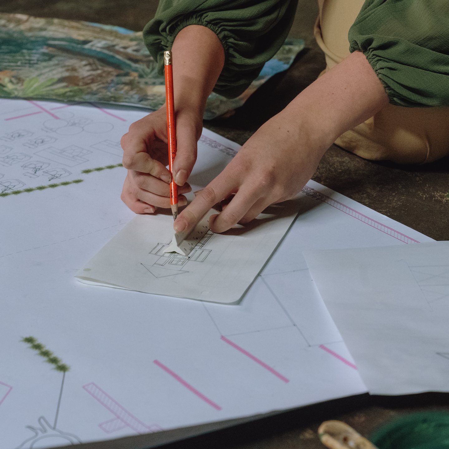 a person drawing on a piece of paper