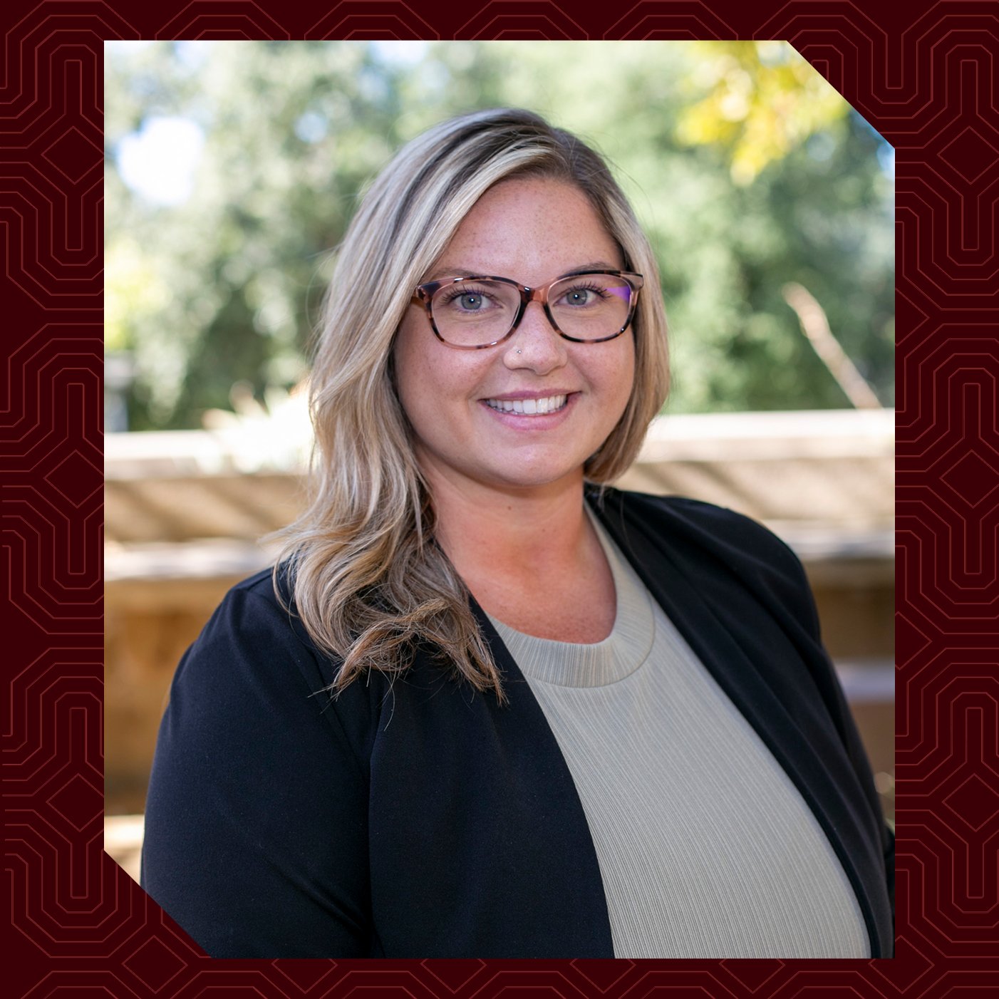 a woman wearing glasses and a black jacket