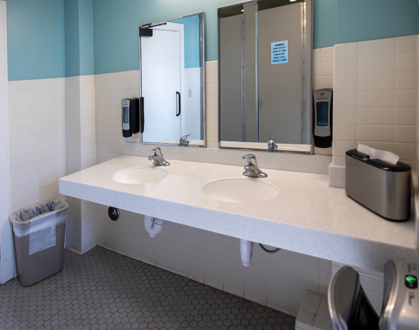 a bathroom with two sinks and mirrors