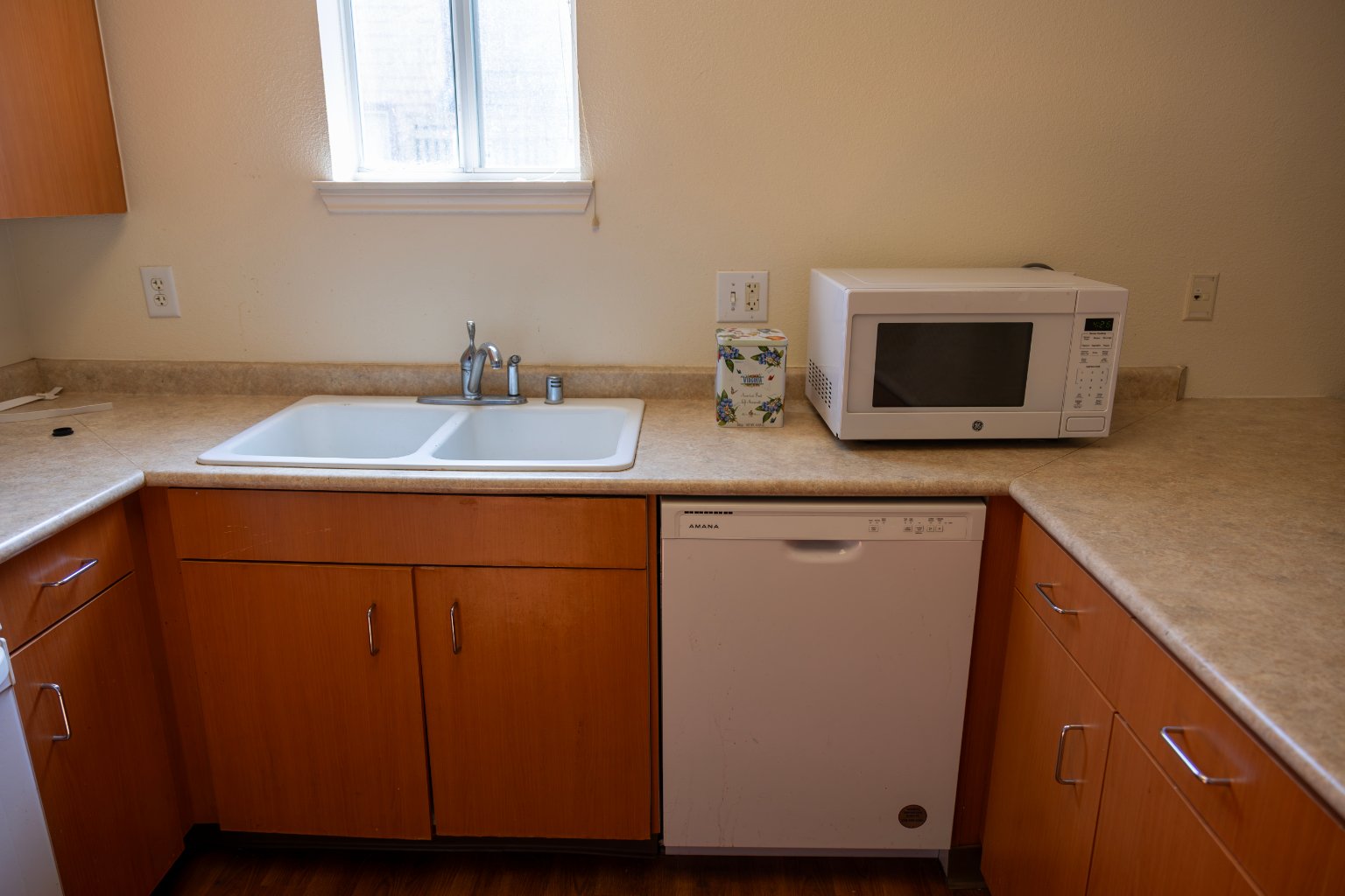 a kitchen with a microwave and dishwasher