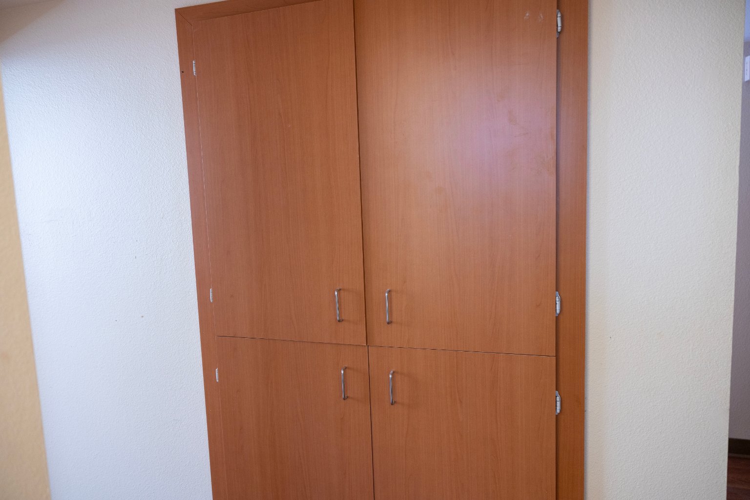 a wooden cabinet with handles