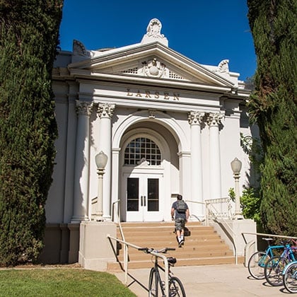 a man walking up stairs in front of Saint Boniface Cathedral