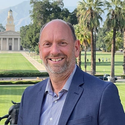 a man in a suit smiling