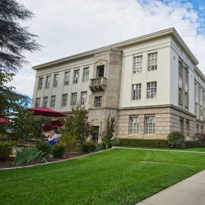 a building with a lawn and a sidewalk