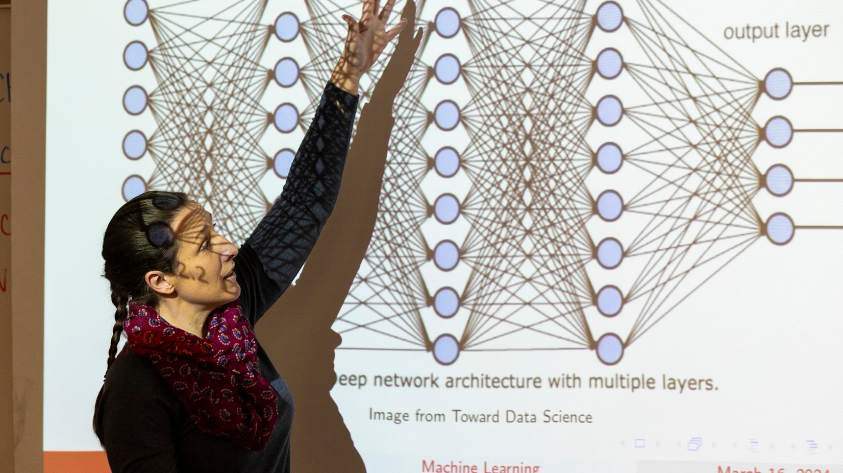 a person standing in front of a projection screen