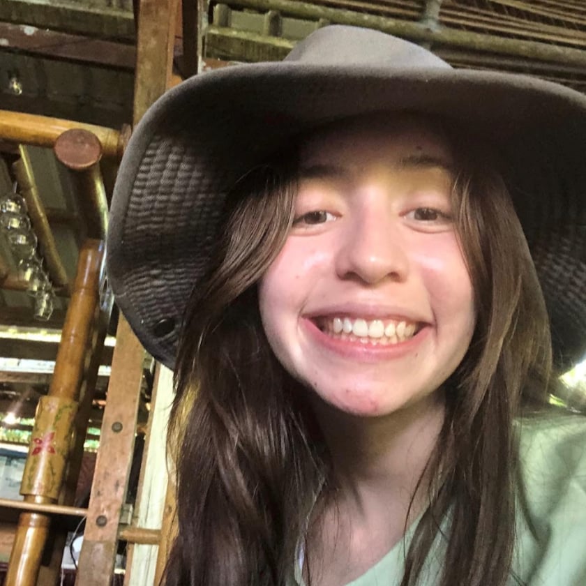 a girl wearing a hat smiling