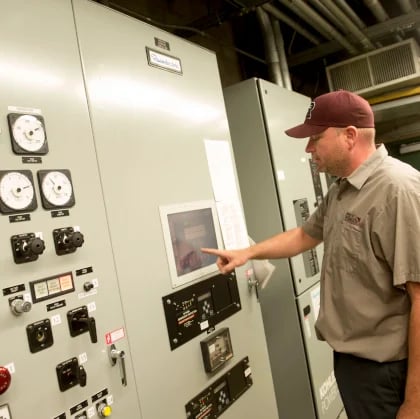 a man pointing at a machine