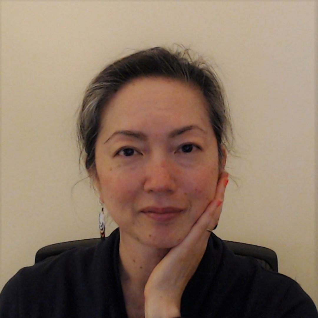 a woman with her hand on her chin