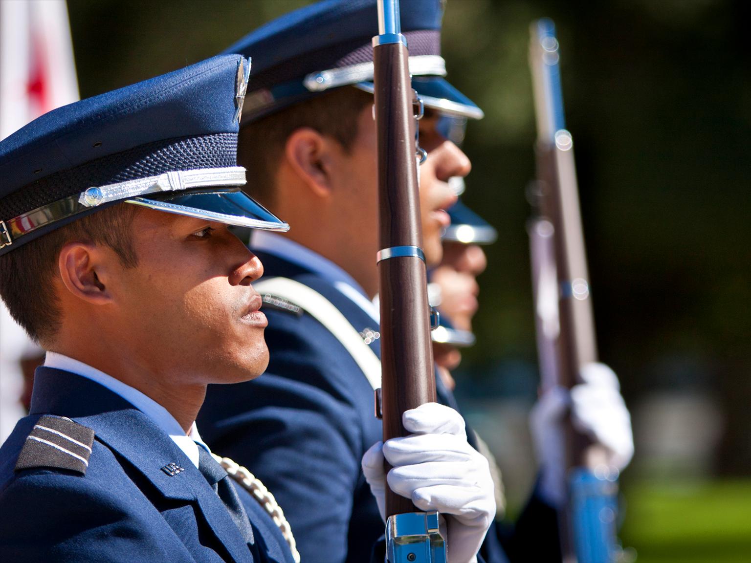 a group of men in uniform holding guns