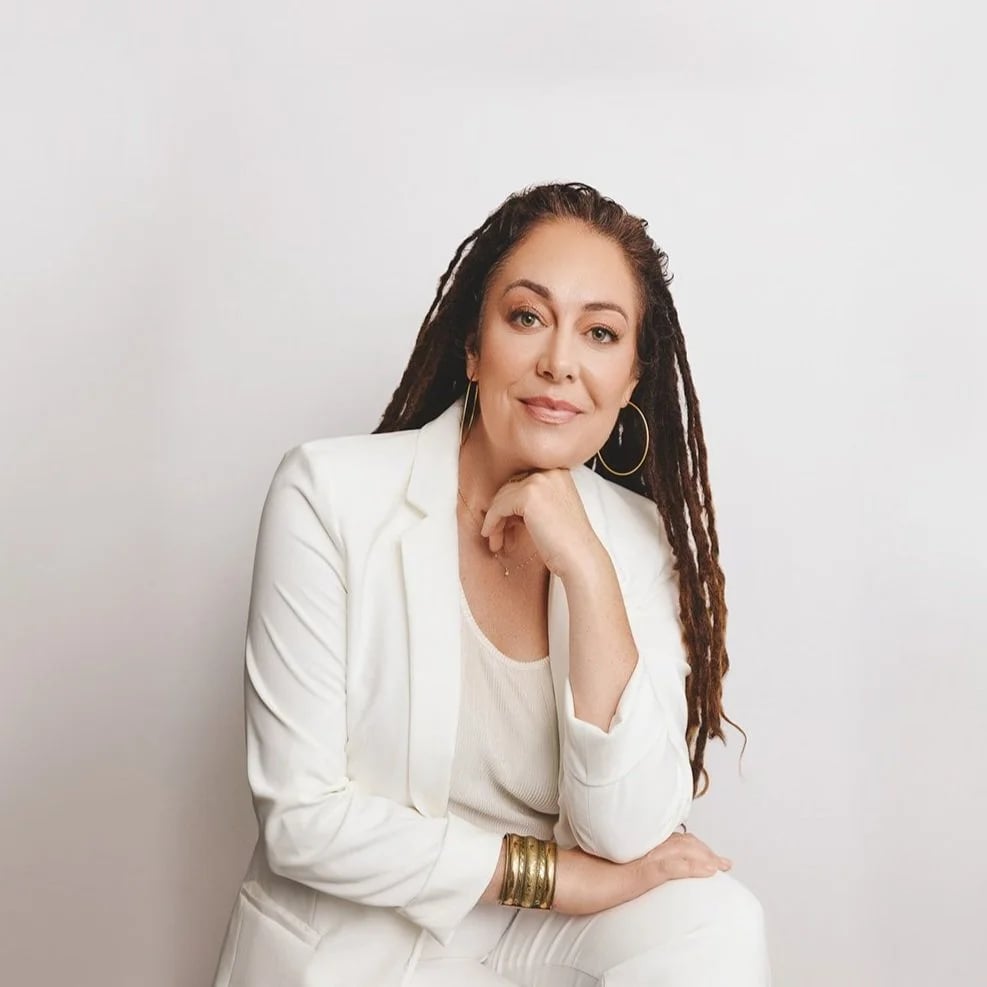 a woman in white suit with long dreadlocks