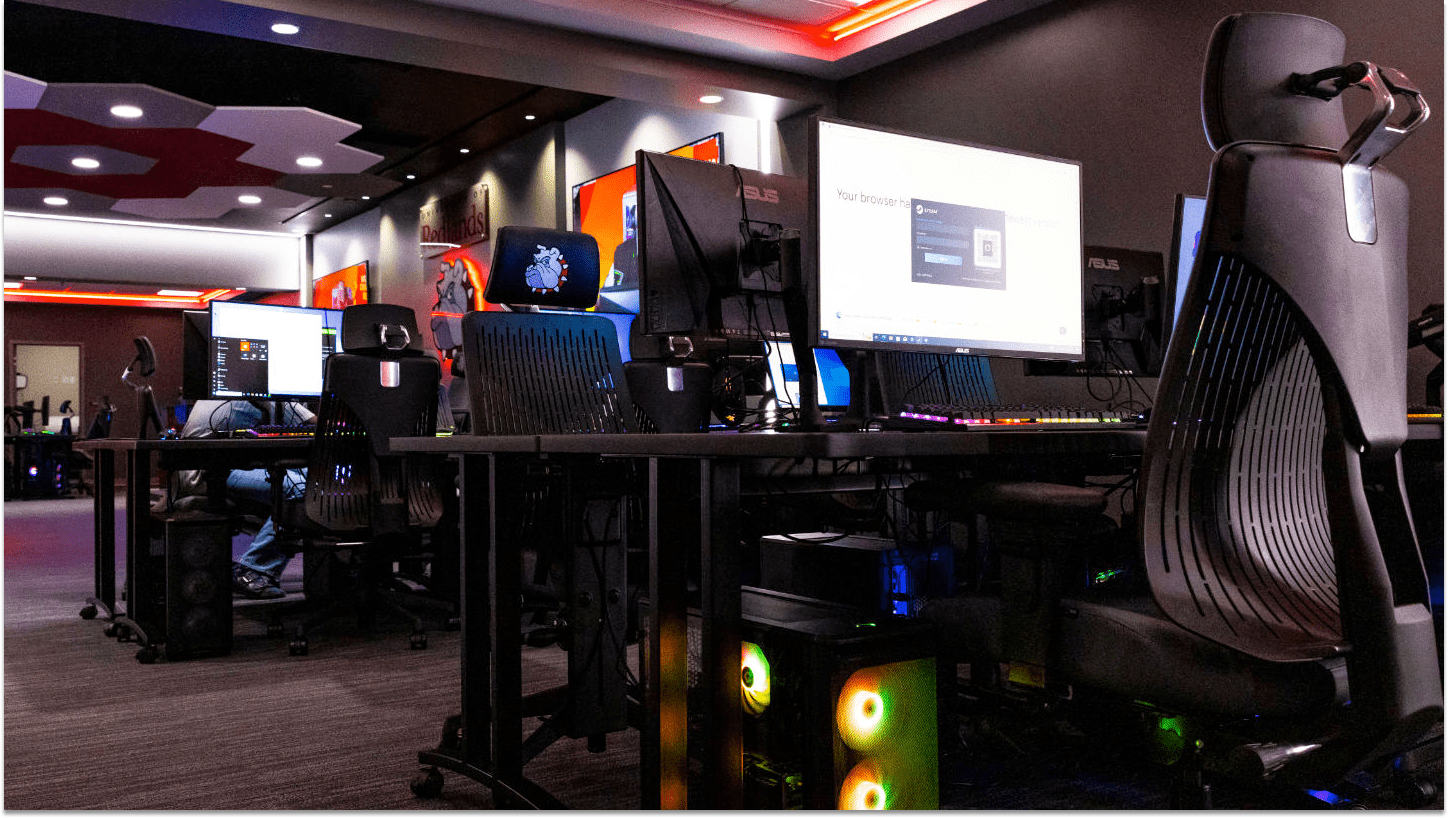 a room with computers and a large screen