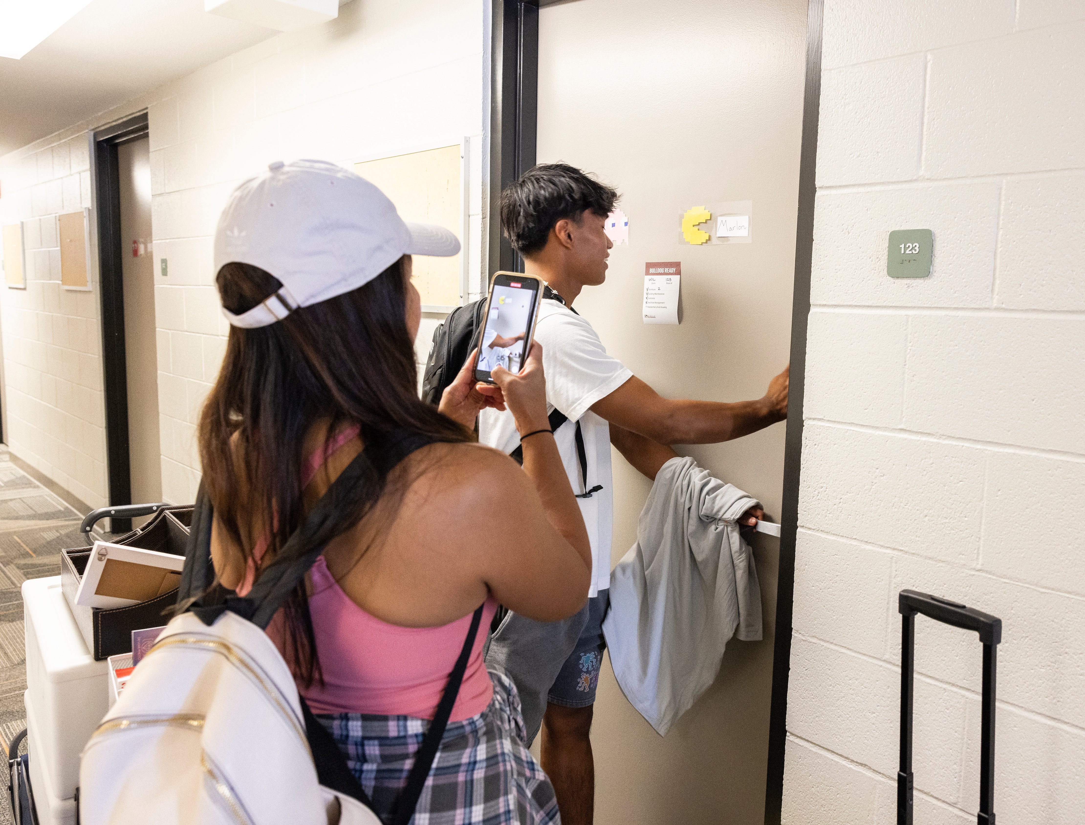 a man and woman taking a picture of themselves in a mirror