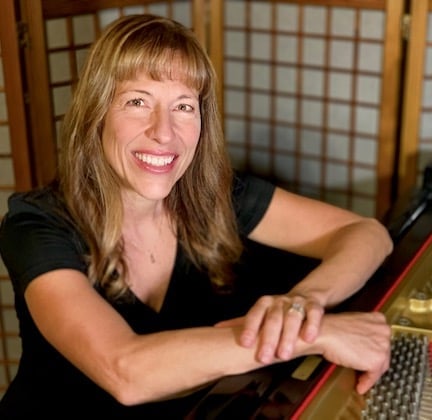 a woman sitting at a piano