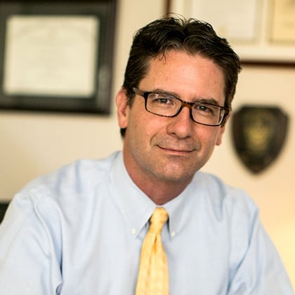 a man wearing glasses and a blue shirt