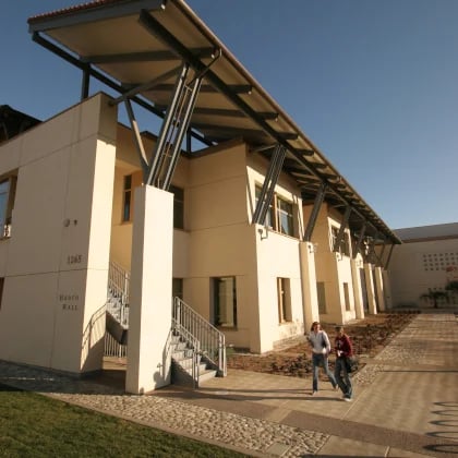 a couple of people walking in front of a building